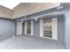 Covered front porch featuring neutral paint and large windows with white shutters at 3205 Moog Rd, Holiday, FL 34691