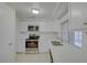 Bright kitchen with stainless steel appliances and white cabinets, perfect for cooking at 3205 Moog Rd, Holiday, FL 34691