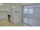 Well-lit kitchen featuring neutral paint, stainless steel dishwasher, and sliding glass door at 3205 Moog Rd, Holiday, FL 34691