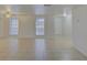 Living room showcasing tile floors, recessed lights, and two bright windows at 3205 Moog Rd, Holiday, FL 34691