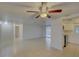 Open-concept living room with neutral tile flooring and seamless transition to the kitchen at 3205 Moog Rd, Holiday, FL 34691