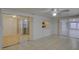 Bright living room featuring tile floors, sliding glass doors, and a ceiling fan at 3205 Moog Rd, Holiday, FL 34691