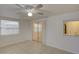 Bright living room featuring tile floors, sliding glass doors, and white paint at 3205 Moog Rd, Holiday, FL 34691