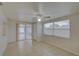 Bright living room with tile floors, ceiling fan, and sliding glass door at 3205 Moog Rd, Holiday, FL 34691