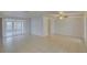 Spacious living room boasts tile flooring and sliding glass doors at 3205 Moog Rd, Holiday, FL 34691