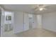 Main bedroom featuring tile floors, multiple access points to other areas, and ceiling fan at 3205 Moog Rd, Holiday, FL 34691