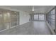 Bright and airy sunroom with tiled floors, large sliding glass door, and lots of windows at 3205 Moog Rd, Holiday, FL 34691