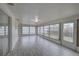 Sunroom featuring tile floor, lots of windows providing natural light, and an exterior door at 3205 Moog Rd, Holiday, FL 34691