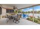 Covered patio with table and chairs, overlooking the water at 3339 Poinsettia Dr, Hernando Beach, FL 34607