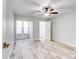 Spacious bedroom with ceiling fan and wood-look flooring at 40 Aster Pl, Oldsmar, FL 34677