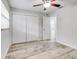 Bedroom with white closet doors and wood-look tile at 40 Aster Pl, Oldsmar, FL 34677