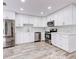 Updated kitchen with white cabinets and stainless steel appliances at 40 Aster Pl, Oldsmar, FL 34677