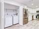 Convenient laundry room with washer, dryer, and shelving at 40 Aster Pl, Oldsmar, FL 34677
