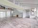 Open concept living area with high ceilings and wood-look tile floors at 40 Aster Pl, Oldsmar, FL 34677