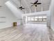 Open living area with vaulted ceilings and wood-look floors at 40 Aster Pl, Oldsmar, FL 34677