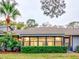 Updated screened patio with lush landscaping at 40 Aster Pl, Oldsmar, FL 34677