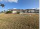 Large backyard with grassy area and water view at 495 Bath Club N Blvd, North Redington Beach, FL 33708