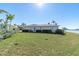 Large backyard with grassy area and water view at 495 Bath Club N Blvd, North Redington Beach, FL 33708