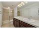 Double vanity bathroom with a large shower and updated fixtures at 5152 Bay Isle Cir, Clearwater, FL 33760