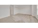Bedroom with carpet, private bathroom access, and a large closet at 5152 Bay Isle Cir, Clearwater, FL 33760