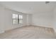 Well-lit bedroom with carpeted floors and a large window at 5152 Bay Isle Cir, Clearwater, FL 33760