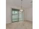 Dining area with chandelier and sliding glass doors at 5152 Bay Isle Cir, Clearwater, FL 33760