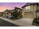 Tan three-story townhome with two-car garage, at dusk at 5152 Bay Isle Cir, Clearwater, FL 33760