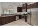 Modern kitchen featuring stainless steel appliances and granite countertops at 5152 Bay Isle Cir, Clearwater, FL 33760