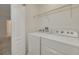Convenient laundry room with washer, dryer, and shelving at 5152 Bay Isle Cir, Clearwater, FL 33760