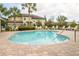 Community pool with surrounding lounge chairs and patio at 5152 Bay Isle Cir, Clearwater, FL 33760