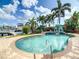 Relaxing kidney-shaped pool with a view of the water at 565 Crystal Dr, Madeira Beach, FL 33708