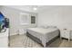 Spacious bedroom with large bed, window coverings, and modern flooring at 6108 Pershing Ne St, St Petersburg, FL 33703