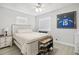 Spacious bedroom with a wooden bed frame and ceiling fan at 6108 Pershing Ne St, St Petersburg, FL 33703