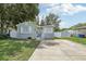 Gray house with stone accents, a large yard, and a white fence at 6108 Pershing Ne St, St Petersburg, FL 33703