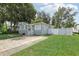 Gray house with stone base, white fence, and a spacious driveway at 6108 Pershing Ne St, St Petersburg, FL 33703