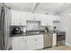 White kitchen with stainless steel appliances and granite countertops at 6108 Pershing Ne St, St Petersburg, FL 33703