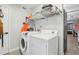 Laundry room with washer, dryer, and overhead shelving at 6108 Pershing Ne St, St Petersburg, FL 33703