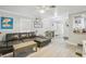 Spacious living room with a sectional sofa and wood-look floors at 6108 Pershing Ne St, St Petersburg, FL 33703