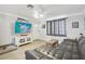 Relaxing living room featuring a sectional sofa and large TV at 6108 Pershing Ne St, St Petersburg, FL 33703