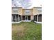 Back exterior view showing a townhome with a screened patio at 6603 Osprey Lake Cir, Riverview, FL 33578
