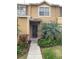 Inviting exterior featuring a charming townhouse with a well-maintained walkway and landscaping at 6603 Osprey Lake Cir, Riverview, FL 33578