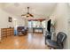 Living room with hardwood floors, ceiling fan and a recliner at 6610 Cambridge Park Dr, Apollo Beach, FL 33572