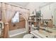 Updated bathroom with a shower/tub combo and shelving at 704 E Broad St, Tampa, FL 33604