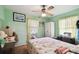 Charming bedroom with floral bedding and ceiling fan at 704 E Broad St, Tampa, FL 33604