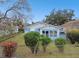 A charming light blue house with a well-maintained front yard at 704 E Broad St, Tampa, FL 33604