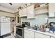 Galley kitchen with stainless steel appliances and wood cabinets at 704 E Broad St, Tampa, FL 33604