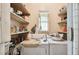 Functional laundry room with washer, dryer, and shelving at 704 E Broad St, Tampa, FL 33604