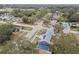 An aerial view showcasing a house with a solar panel system and a screened-in pool at 7101 69Th N St, Pinellas Park, FL 33781