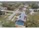 An aerial view showcasing a house with a solar panel system and a screened-in pool at 7101 69Th N St, Pinellas Park, FL 33781