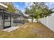 Large backyard with grassy area and white fence at 7101 69Th N St, Pinellas Park, FL 33781